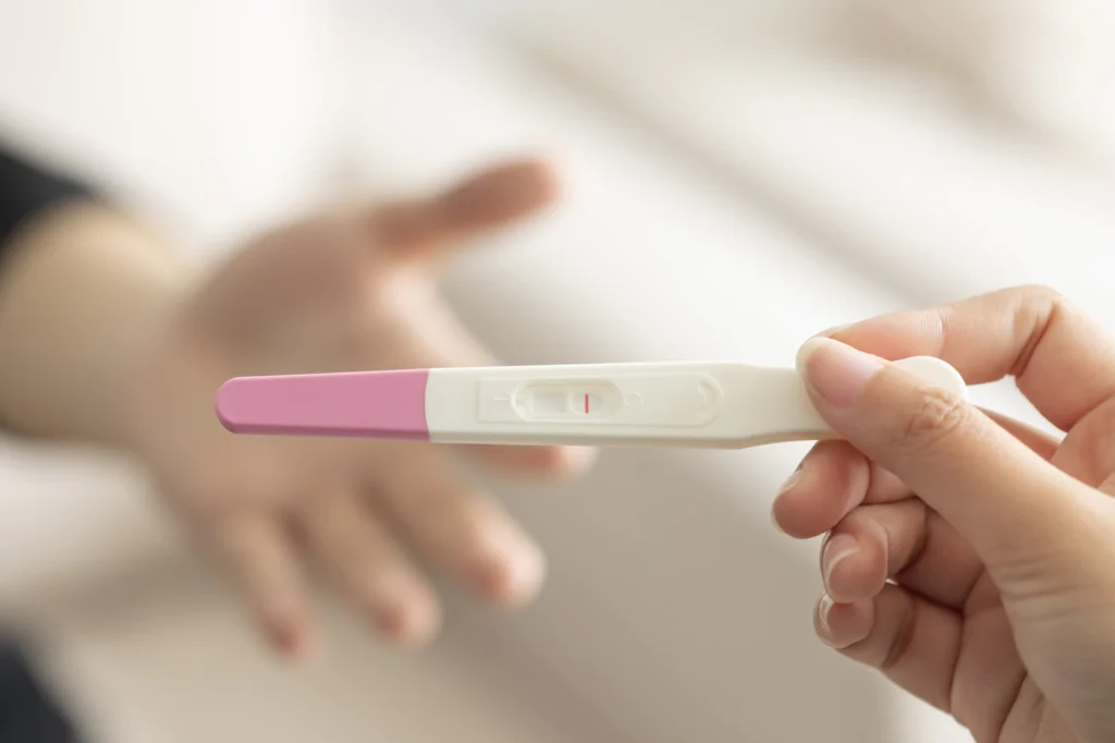 hand holding pregnancy test